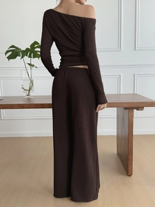 Rear view of brown textured two-piece set featuring off-shoulder top and wide-leg pants