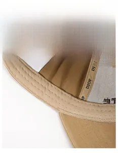 Close-up of wide sweatband and stitching on khaki cotton distressed baseball cap