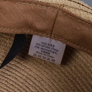 Detail of internal adjustable sweatband and label on premium raffia straw hat