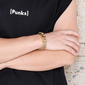 Close-up of men's gold chunky chain bracelet with woven links and square buckle