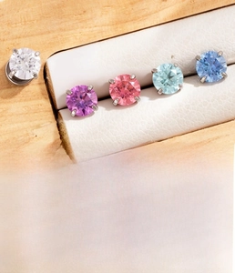 Macro detail of 4mm colorful zircon stud earrings set made of silver surgical steel