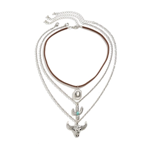 Detail showing layered bohemian necklaces with turquoise cactus and ox skull pendants