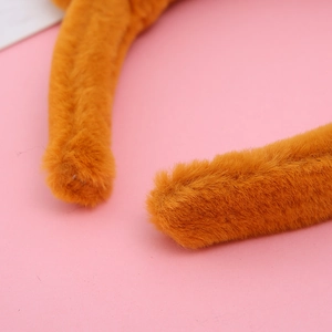 Close-up of soft orange plush fabric and rounded end of the animal ear headband