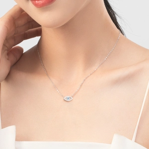 S925 sterling silver Evil Eye pendant necklace with blue and clear crystals on a model