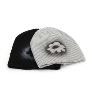 Thick ribbed knit beanies in black and grey featuring white floral spray-paint designs