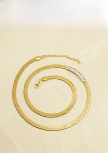 Macro shot of 18K gold plated stainless steel snake chain with seven rectangular zircons