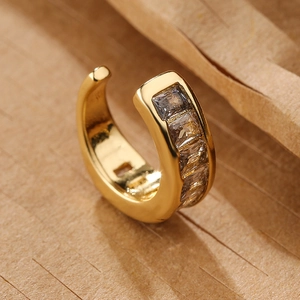 Detail of 18K gold plated U-shaped ear cuff with baguette-cut zircon stones inlay
