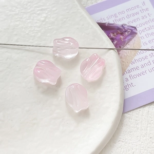 Detailed view of translucent pink tulip glass beads for DIY jewelry making and crafts