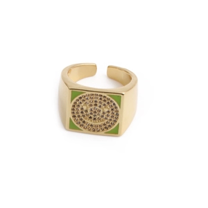 Macro detail of square green zircon smiley face ring with gold plating and rhinestones
