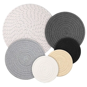 Detailed view of woven cotton rope coasters in gradient grey tones and various sizes