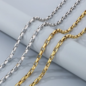 Close-up of gold and silver 18K plated stainless steel box chains with metallic luster