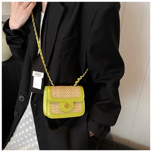 Detail of avocado green straw patchwork crossbody bag with golden flower metal clasp