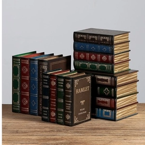 Detailed view of vintage faux book storage boxes with gold foil embossing and leather texture