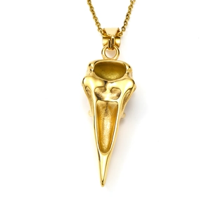 Detailed close-up of a golden bird skull pendant in polished stainless steel
