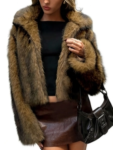 Detail shot of plush brown faux fur jacket paired with shiny brown leather skirt