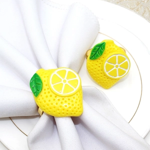 Detailed view of yellow lemon napkin rings with realistic texture and green leaves