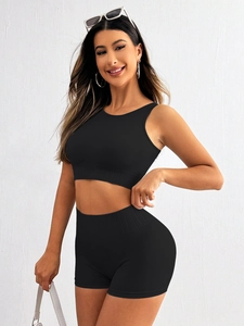 Close-up of black ribbed seamless knit sports set with crop tank top and high waist shorts