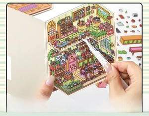 Macro view of DIY scrapbooking sticker set with tweezers and cartoon bakery scene