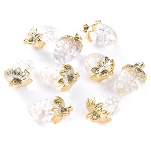 Detailed macro view of clear strawberry charms with gold loops for DIY jewelry making
