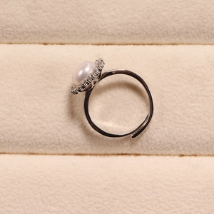 Elegant adjustable ring featuring a lustrous white pearl and sparkling zircon halo