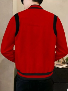 Back view of a casual men's red and black varsity jacket with ribbed hem detail
