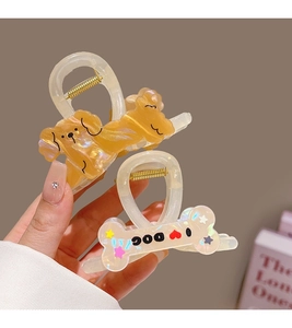 Detailed view of the iridescent cartoon poodle and I Love Dog bone hair claw clips
