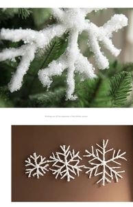 Detail of white glitter snowflakes hanging on tree and three sizes flat layout display