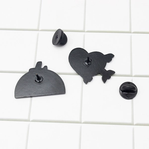 Black metal airplane lapel pins back view with rubber clutch on a grid background