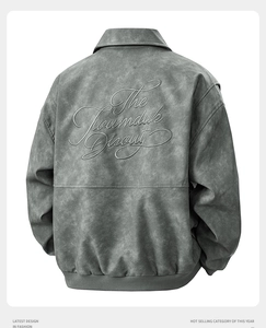 Detail of gray leather jacket with intricate 3D embroidery on the back and ribbed hem