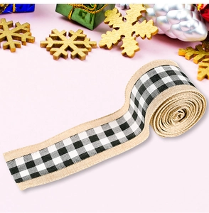 Detail of Christmas burlap ribbon roll with black and white plaid patterns for gift wrapping