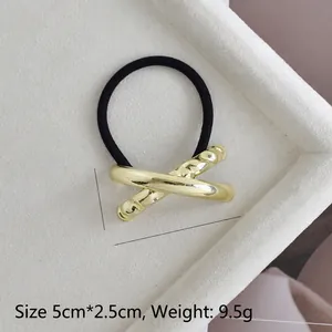 Detailed size view of gold U-shaped alloy ponytail holder on velvet tray, 5cm x 2.5cm