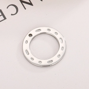 Polished silver stainless steel circular geometric pendant with textured hammer patterns