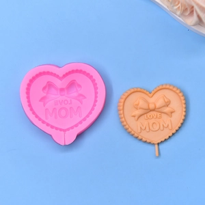 Detail showing heart-shaped silicone mold with bow relief and LOVE MOM text engraving
