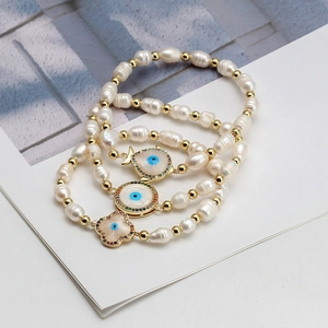 Three-piece set of freshwater pearl bracelets with blue evil eye and hamsa pendants