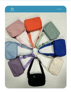Top view of compact nylon crossbody waist bags displayed in eight vibrant assorted colors