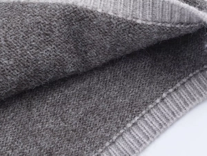 Close-up of soft grey knitted wool fabric with ribbed texture and fuzzy surface