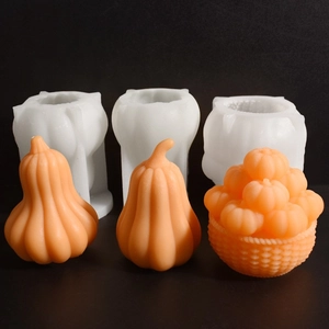 Detail view of pumpkin silicone molds and orange finished candles on black backdrop