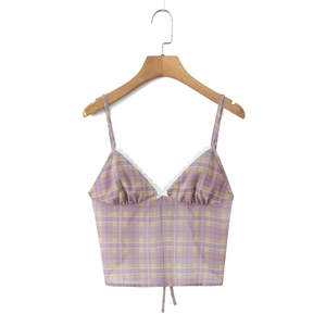 Detail of purple and yellow plaid camisole with white lace trim and bow on wooden hanger