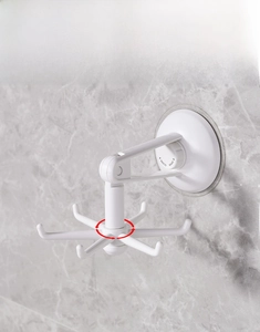 Macro view of white 360 degree rotating kitchen hook with six functional prongs