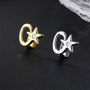 Star-shaped gold and silver ear cuffs featuring sparkling cubic zirconia in C-ring design