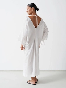 White cotton maxi dress with deep V-back tie and minimalist loose fit for summer