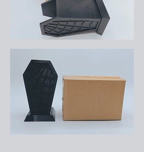 Detailed view of Gothic black coffin brush holder with spiderweb texture and packaging