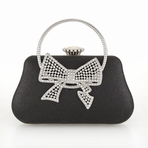 Elegant black evening clutch bag with a large sparkling rhinestone bow and metal handle
