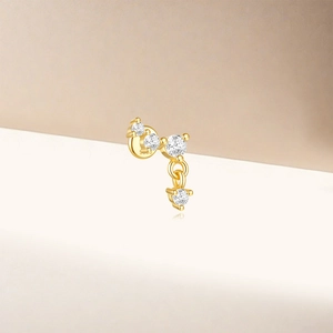 Close-up of golden S925 silver earring featuring cubic zirconia stars and moon drops