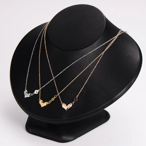Three geometric heart pendant necklaces in silver, gold, and rose gold finish
