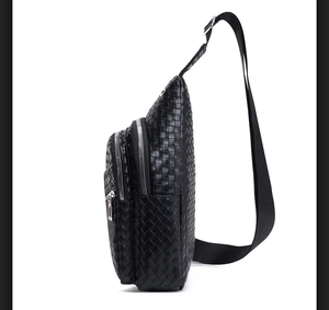 Side view showing woven leather texture and multiple zipper compartments of the black bag