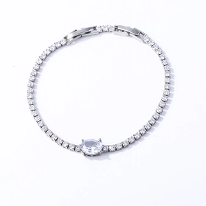 Close-up of a silver tennis bracelet with a large oval centerpiece and round cubic zirconia
