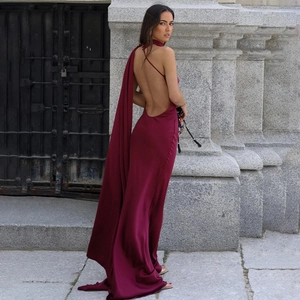 Macro view of burgundy backless halter maxi dress with flowing silk ribbon detail
