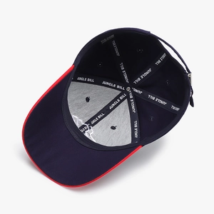 Dark blue structured baseball cap with red brim piping and interior brand tape detail