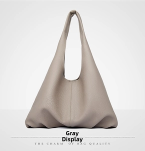 Detailed view of large grey hobo bag showing high-quality lychee grain leather texture